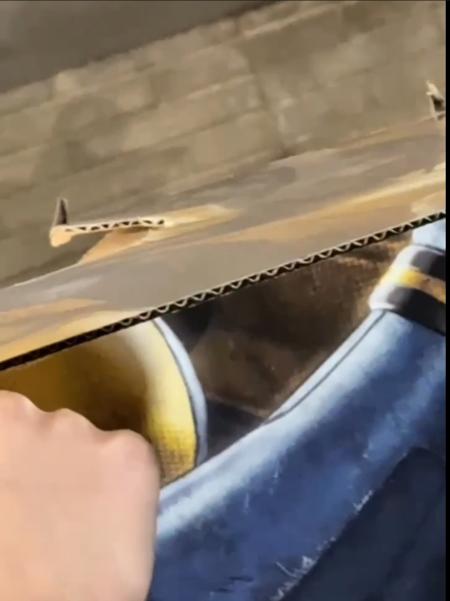 Seams cut through the front of the cardboard